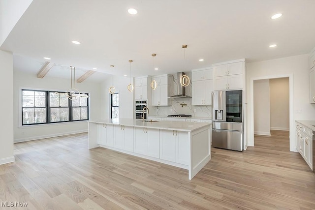 2762 Rocky Ridge Dr, Westlake, OH 44145 - kitchen featuring light wood-style flooring, wall chimney exhaust hood, light countertops, and appliances with stainless steel finishes