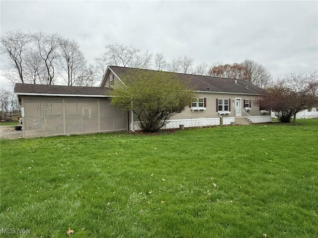 back of house with a yard