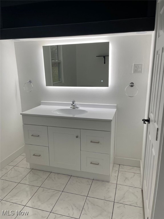 3644 Eldersville Rd, Colliers, WV 26035 - bathroom featuring baseboards, marble finish floor, and vanity