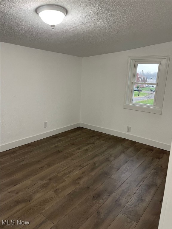 3644 Eldersville Rd, Colliers, WV 26035 - spare room featuring dark wood-style flooring, baseboards, and a textured ceiling