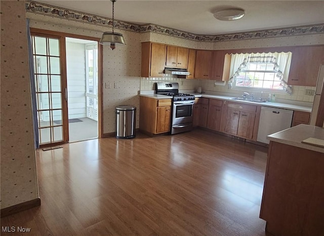 3509 11th Ave, Vienna, WV 26105 - kitchen with stainless steel gas stove, dark wood-type flooring, wallpapered walls, dishwasher, and extractor fan