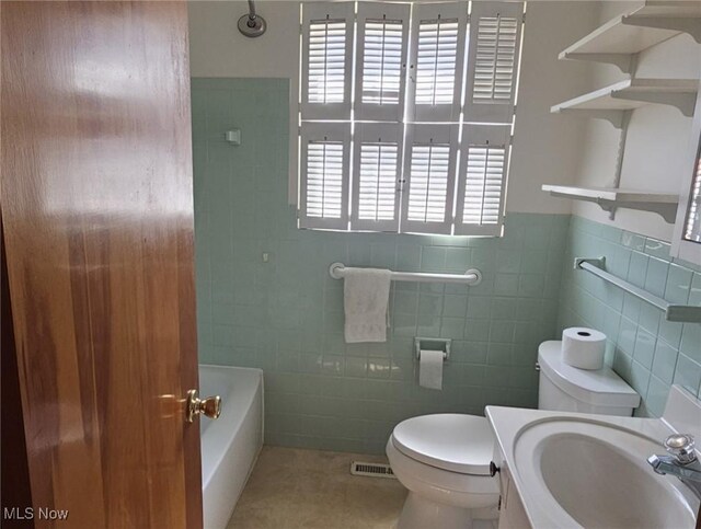 3509 11th Ave, Vienna, WV 26105 - full bath featuring toilet, plenty of natural light, and tile walls
