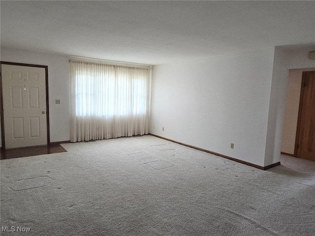 3509 11th Ave, Vienna, WV 26105 - unfurnished living room with baseboards and carpet
