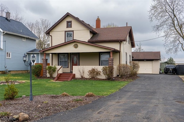1313 Linwood Ave SW, Canton, OH 44710 - traditional-style house featuring a porch, a garage, a front yard, and an outdoor structure