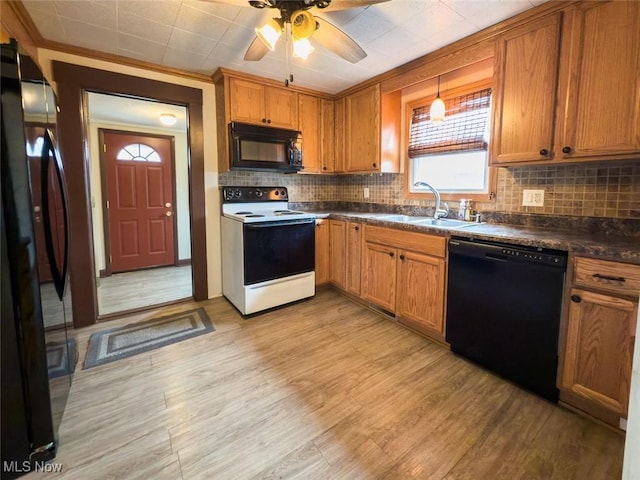 1313 Linwood Ave SW, Canton, OH 44710 - kitchen with backsplash, dark countertops, black appliances, ceiling fan, and a sink