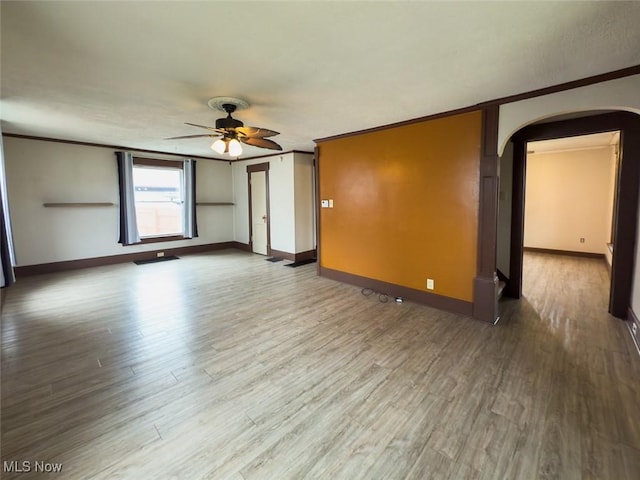 1313 Linwood Ave SW, Canton, OH 44710 - spare room with wood finished floors, arched walkways, ornamental molding, and ceiling fan