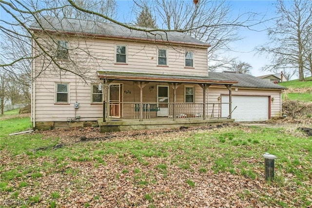 traditional-style house featuring a porch and an attached garage