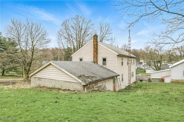 view of property exterior featuring a yard, a shingled roof, and a chimney