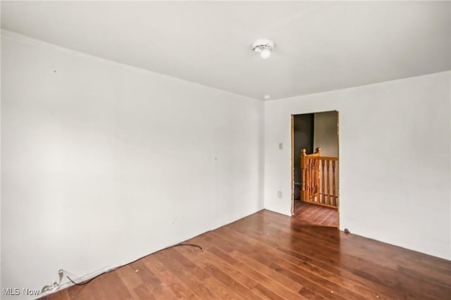 spare room featuring wood finished floors