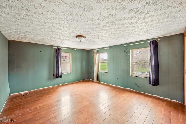 empty room featuring hardwood / wood-style floors and a textured ceiling