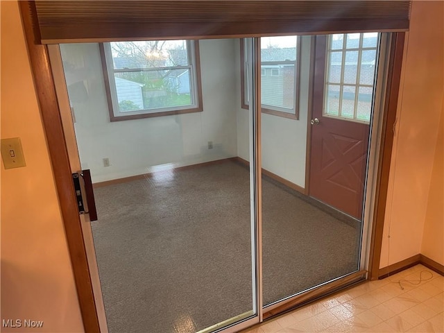 301 E Howard St, Girard, OH 44420 - spare room featuring plenty of natural light, baseboards, and light colored carpet