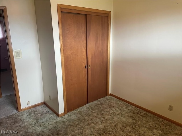 301 E Howard St, Girard, OH 44420 - unfurnished bedroom featuring carpet flooring, a closet, and baseboards