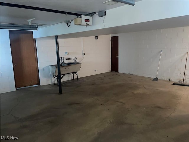 301 E Howard St, Girard, OH 44420 - garage featuring concrete block wall and a garage door opener
