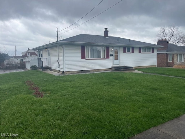 301 E Howard St, Girard, OH 44420 - view of front of property with a front yard, a chimney, and a shingled roof