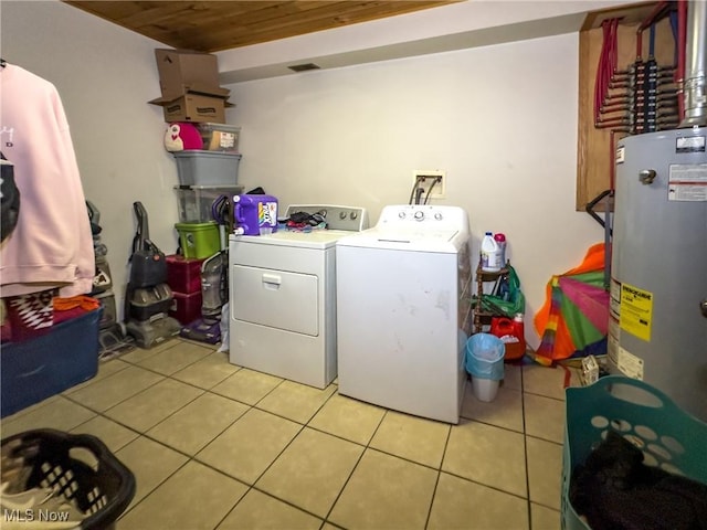 laundry room with light tile patterned floors, washer and dryer, laundry area, wood ceiling, and water heater