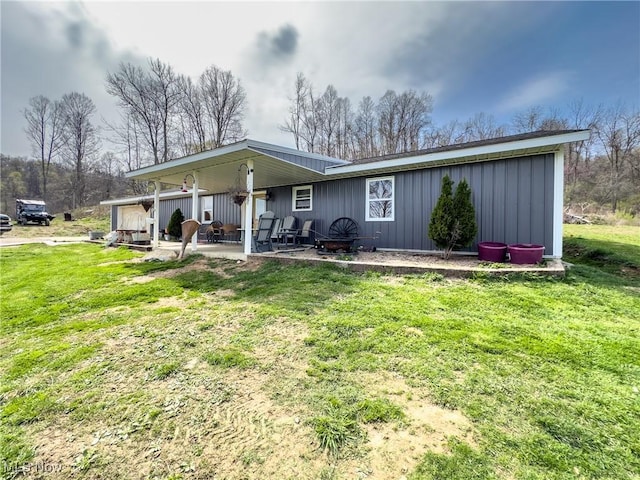 back of property featuring a yard and a patio