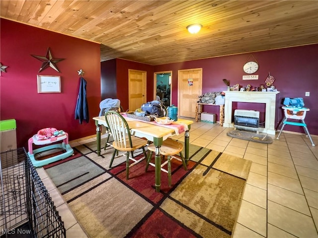 tiled dining area featuring baseboards and wooden ceiling