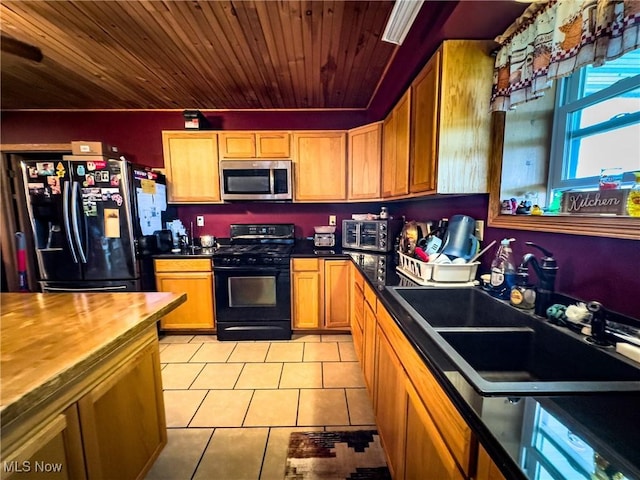 kitchen featuring a sink, wood ceiling, black appliances, butcher block countertops, and light tile patterned flooring