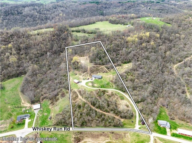 birds eye view of property with a forest view