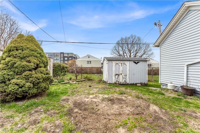 1244 W 69th St, Cleveland, OH 44102 - view of yard featuring fence, an outbuilding, and a storage unit