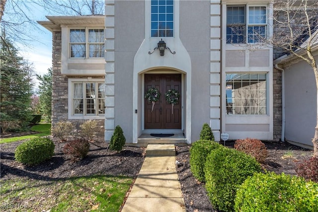 entrance to property with stucco siding and stone siding
