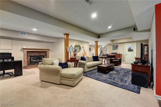 carpeted living area with a brick fireplace, visible vents, and recessed lighting