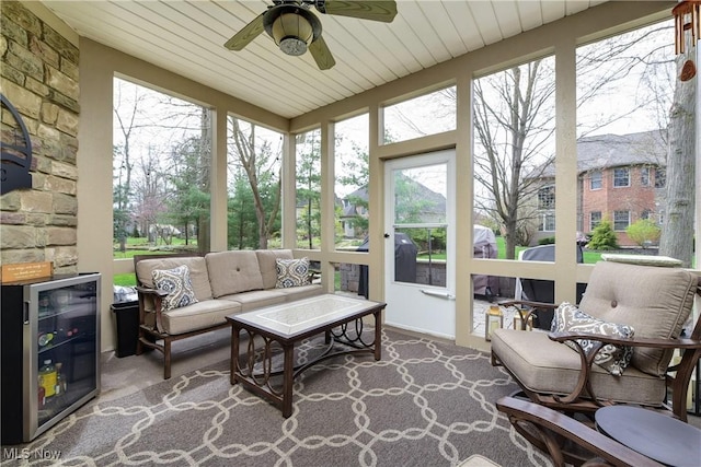 sunroom featuring carpet floors, beverage cooler, and wood ceiling