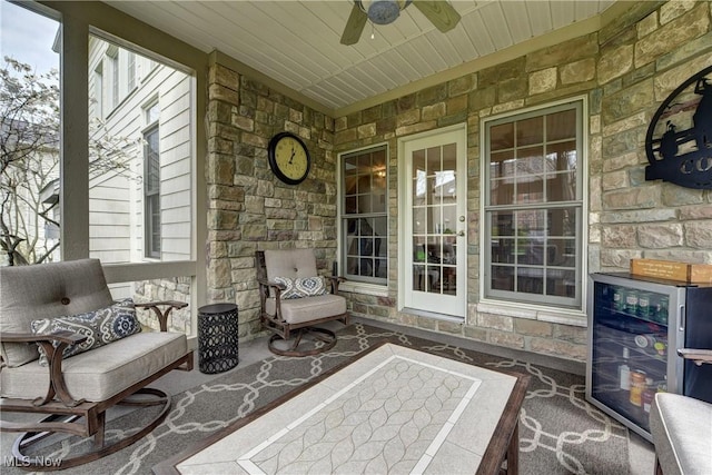 view of patio / terrace with beverage cooler, a ceiling fan, and an outdoor hangout area