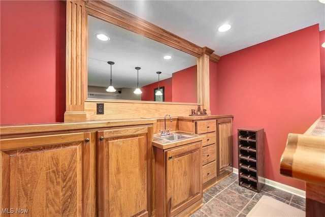 bar with a sink, recessed lighting, decorative light fixtures, and indoor wet bar