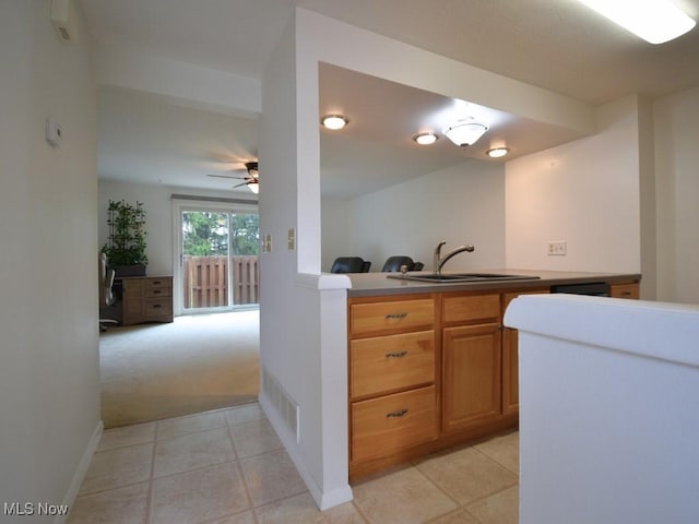 kitchen with baseboards, light tile patterned floors, a ceiling fan, visible vents, and a sink