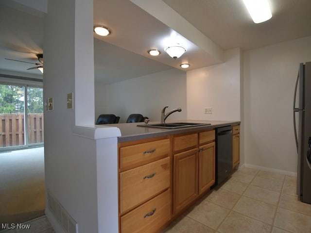 kitchen with freestanding refrigerator, black dishwasher, visible vents, ceiling fan, and a sink