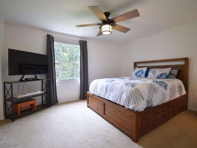 bedroom with light colored carpet, baseboards, and a ceiling fan