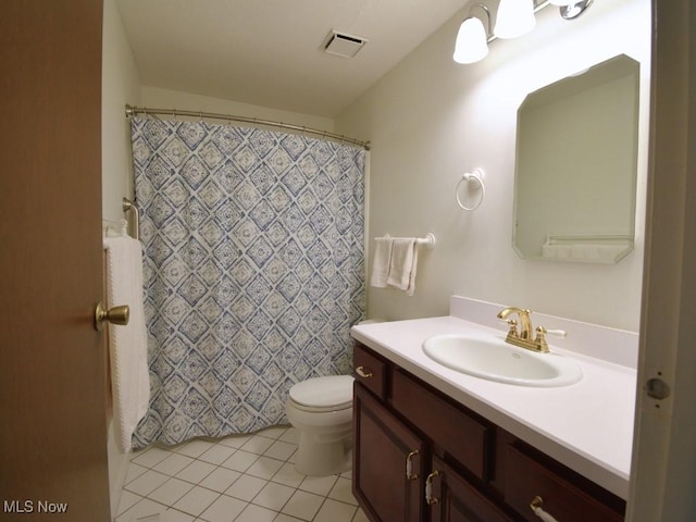 bathroom featuring vanity, tile patterned floors, a shower with curtain, toilet, and visible vents