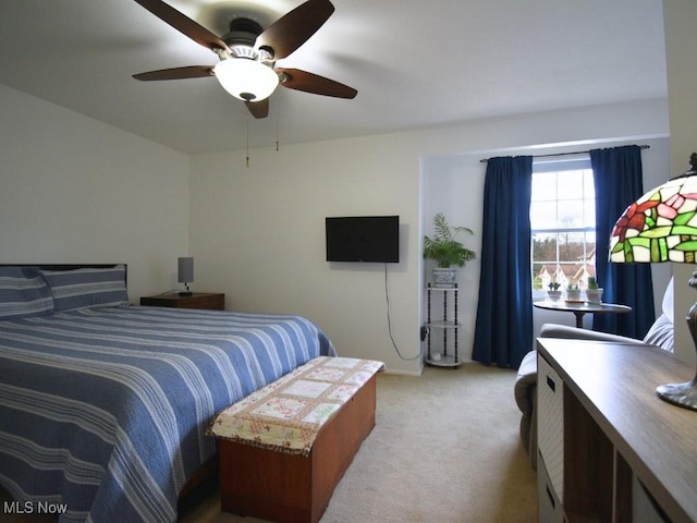 bedroom with light carpet and a ceiling fan