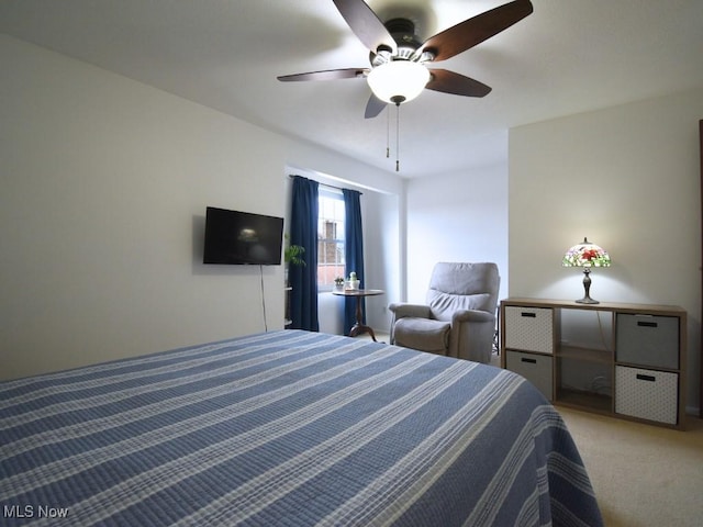 bedroom featuring light carpet and a ceiling fan