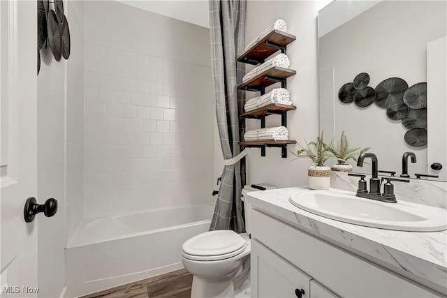 bathroom with toilet, shower / tub combo with curtain, vanity, and wood finished floors