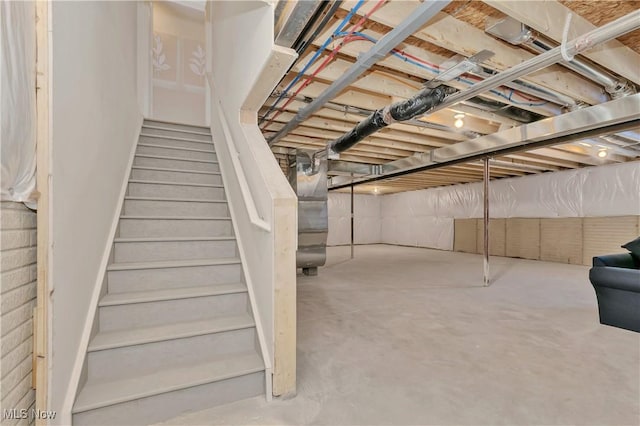 unfinished below grade area featuring stairs