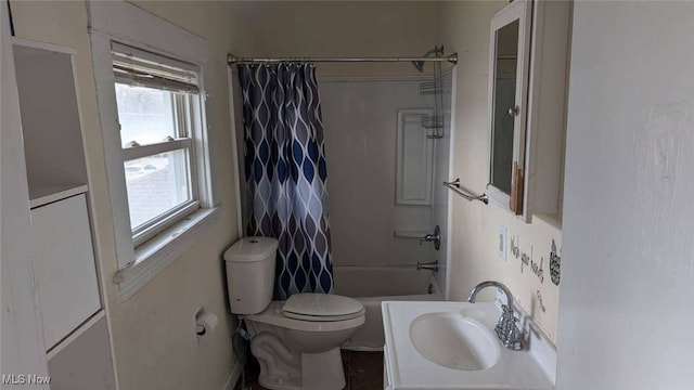 bathroom featuring a sink, toilet, and shower / bathtub combination with curtain