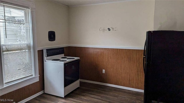 kitchen with dark wood-style flooring, ornamental molding, freestanding refrigerator, a wainscoted wall, and white electric range