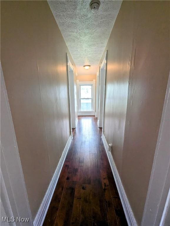 1636 W 8th St, Ashtabula, OH 44004 - hall with a textured ceiling, wood-type flooring, and baseboards