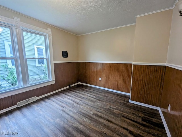1636 W 8th St, Ashtabula, OH 44004 - spare room with wood finished floors, wainscoting, a textured ceiling, baseboards, and crown molding
