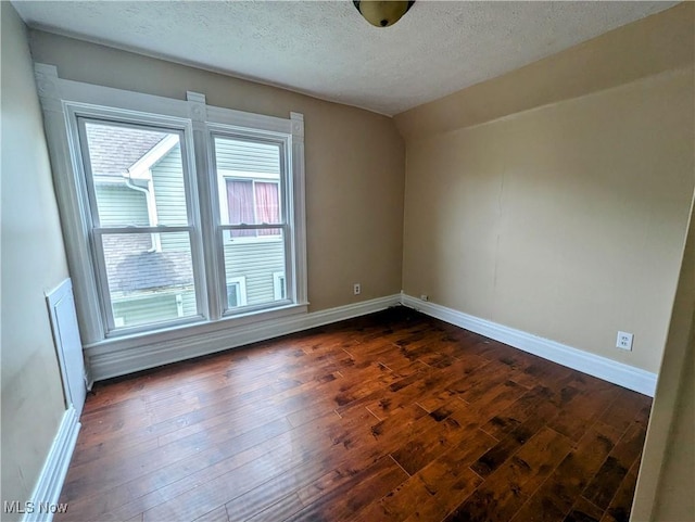 1636 W 8th St, Ashtabula, OH 44004 - spare room with dark wood-style floors, a textured ceiling, and baseboards