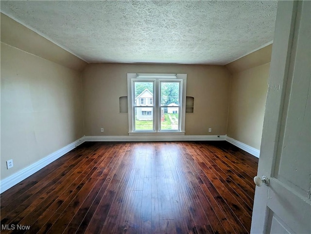1636 W 8th St, Ashtabula, OH 44004 - unfurnished room featuring baseboards, dark wood finished floors, vaulted ceiling, and a textured ceiling