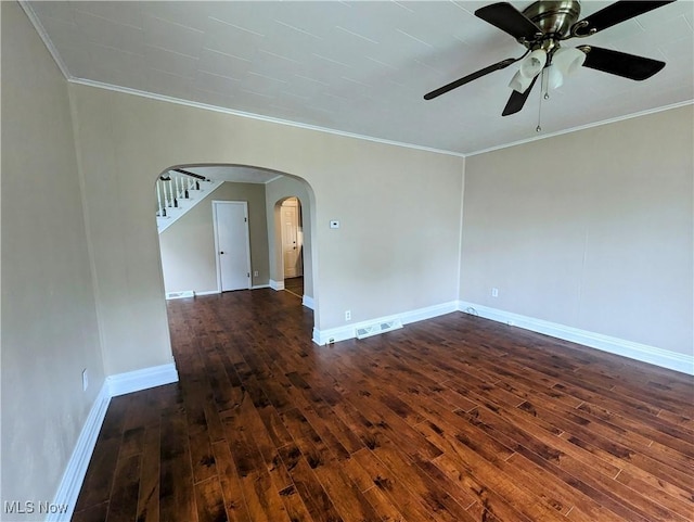1636 W 8th St, Ashtabula, OH 44004 - unfurnished room featuring dark wood finished floors, crown molding, arched walkways, ceiling fan, and baseboards