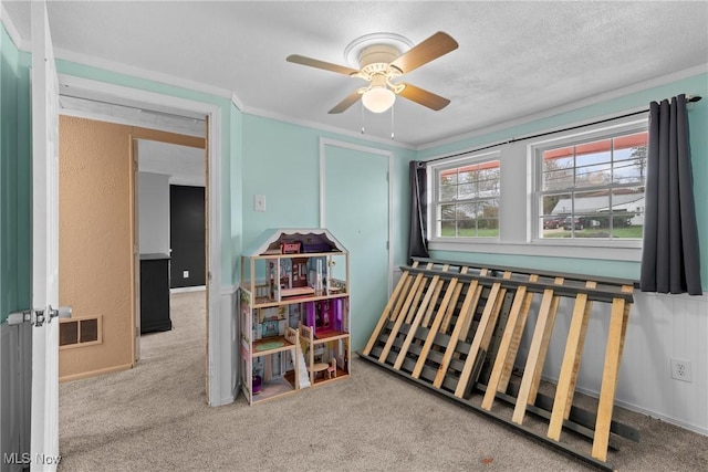 rec room featuring visible vents, a ceiling fan, and carpet floors