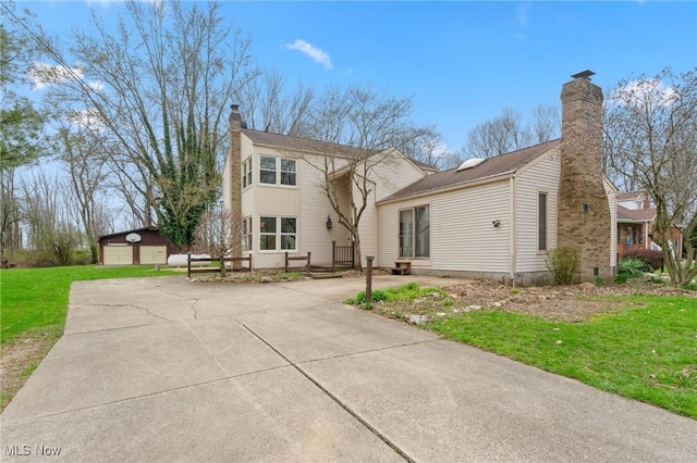 11249 Leffingwell Rd, Berlin Center, OH 44401 - view of front of house with a front lawn, a chimney, and an outbuilding