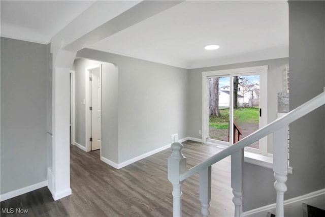 stairway featuring baseboards and wood finished floors