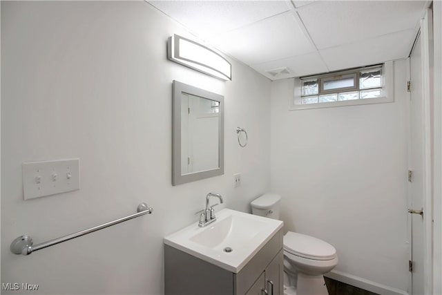 half bathroom with vanity, visible vents, and toilet
