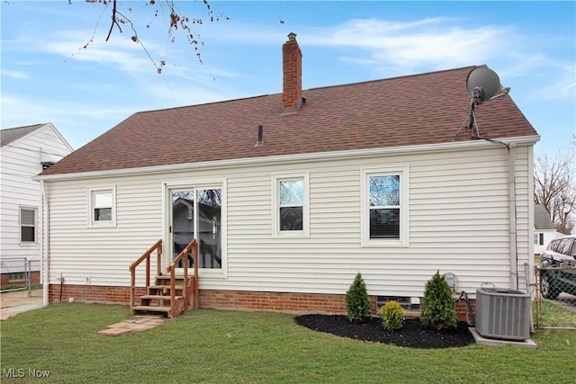 back of house with a yard, central air condition unit, entry steps, and fence