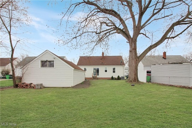 back of property featuring a yard